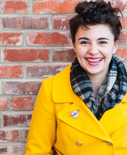 Student in Yellow coat smiling